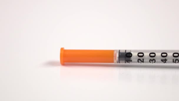 Insulin syringe on white, close up — Stock Video