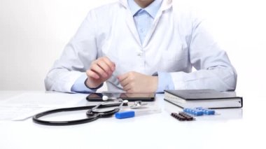 Doktor tabletüzerinde bir şey arıyor ve yazıyor, beyaz