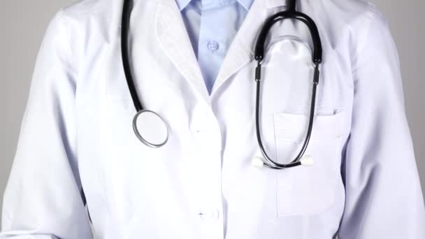 Doctor holding medical syringe and stethoscope, on white — Stock Video