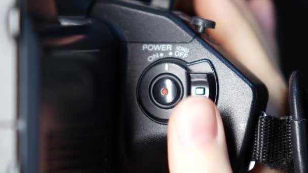 Hand turns on digital camera, close up — Stock Video