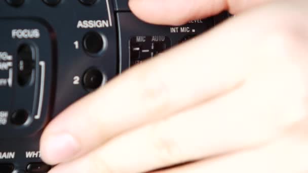 Hand opens audio levels, changes input of video camera, close up — Stock Video