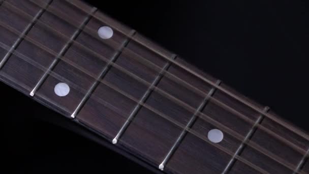 Strings of acoustic guitar, on black, close up, slow motion — Stock Video