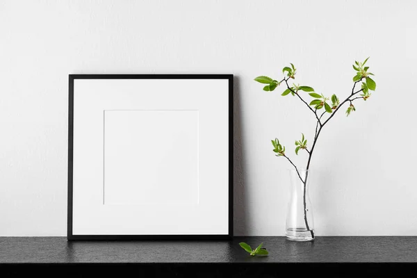 Frame mockup. Poster with plant in vase. Black square photo frame with passepartout. Side view. Can be used as a template for designs and art works.