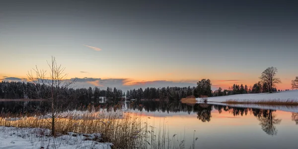 Small lake at winter while orange sky of sunset in bavaria — Stock Photo, Image