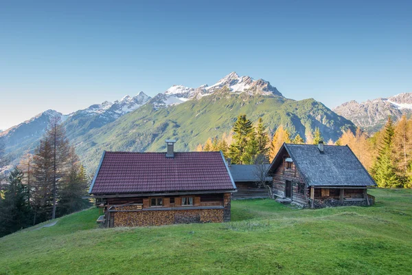 Wooden chalets on mountain meadow — Stock Photo, Image