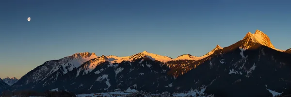 Kışın ışıklı zirveleri ile dağ zinciri Panoraması — Stok fotoğraf