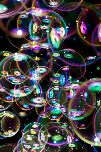 Багато мильних бульбашок літають на чорному тлі — стокове фото