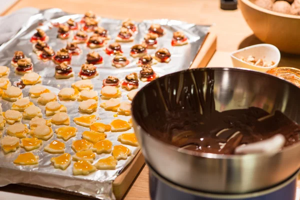 Several christmas cookies on wooden table while baking — Stock Photo, Image