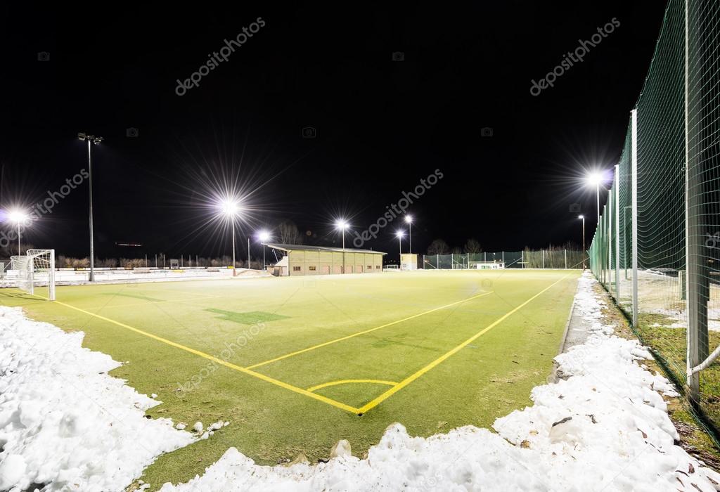 corner of artificial soccer field at night in winter