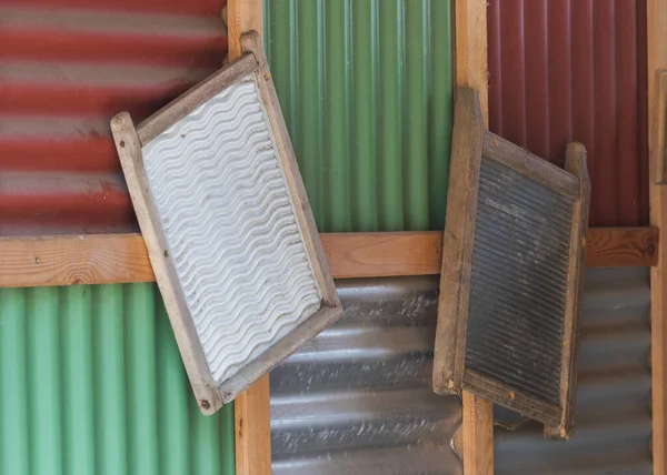 The old clothes rail is hung on a wooden wall.