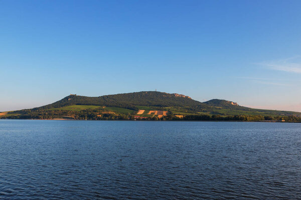 View of Lake Musov and Palava in the Czech Republic. In the background a television transmitter and the ruins of the castle Devicky.