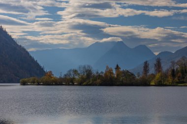 The beautiful mountain lake Grundlsee at the southern foot of the Totes Gebirge mountains in the Styrian part of the Salzkammergut in Austria