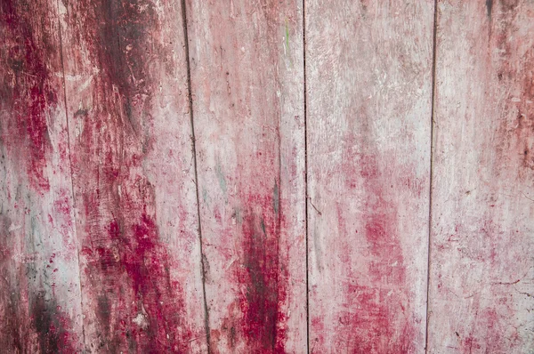 Aging pink and red wooden fence — Stock Photo, Image