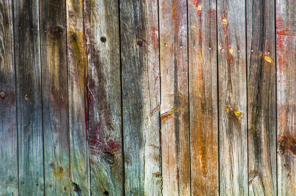 Aging pink and red wooden fence — Stock Photo, Image