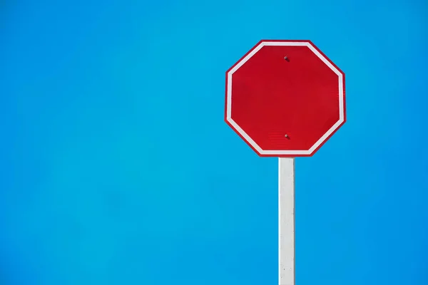 Isolated blank red traffic sign on pole with clipping paths.