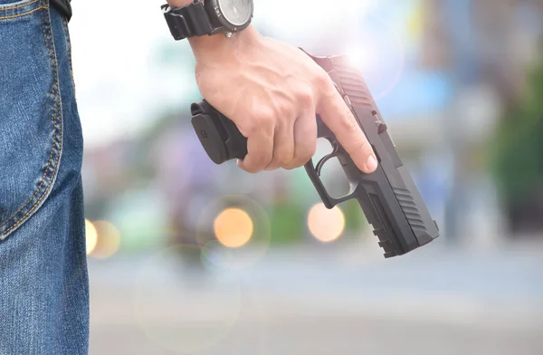 Automatic black 9mm pistol in hands ready to pull the trigger aiming to destination , concept for robbery, gangster, security and shooting sports around the world.