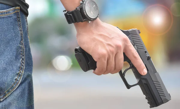 Automatic black 9mm pistol in hands ready to pull the trigger aiming to destination , concept for robbery, gangster, security and shooting sports around the world.
