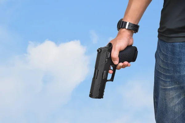 Automatic black 9mm pistol in hands ready to pull the trigger aiming to destination , concept for robbery, gangster, security and shooting sports around the world.