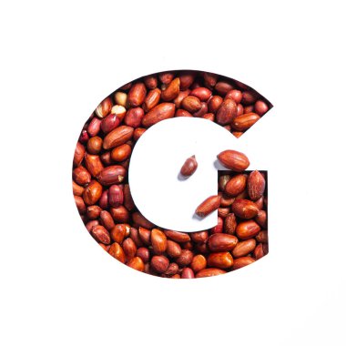 İngiliz alfabesinin G harfi doğal yer fıstığı ve beyaz üzerine izole edilmiş kağıt kesiminden yapılmıştır. Biyolojik organik fındık tipi