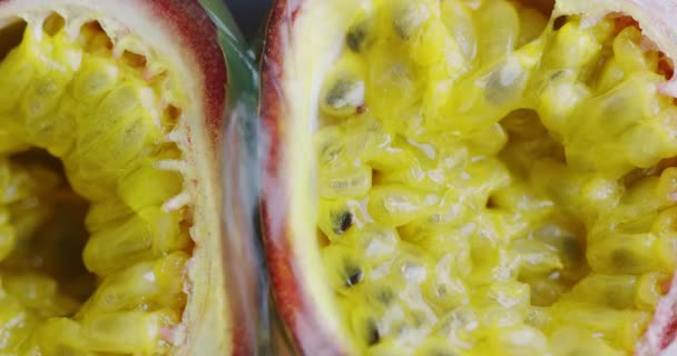 Close up video of fresh bio organic tropical exotic Juice flowing on natural passion fruits, healthy eating concept — Stock Video