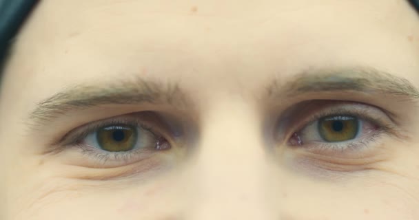 Zbliżenie młodego człowieka. Brązowe oczy faceta z bliska, naturalne piękno. Mężczyzna patrzący na uśmiechniętą kamerę. 4K — Wideo stockowe