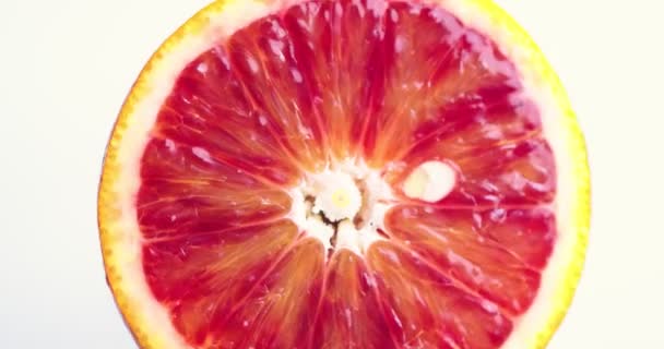 Video of grapefruit citrus fruit rotating on white studio background. Vitamins, healthy dieting concept, close up — Stock Video