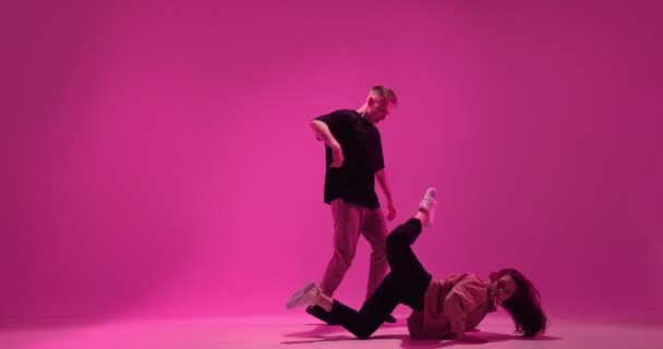 Dansend jong koppel optreden in roze studio licht. Hedendaagse expressieve gepassioneerde dansshow — Stockvideo