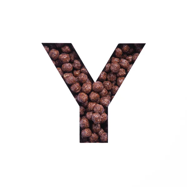 Буква Y алфавита из био-шоколадных шариков с хлопьями и бумаги, вырезанной на белом. Шрифт для магазинов здоровой пищи — стоковое фото