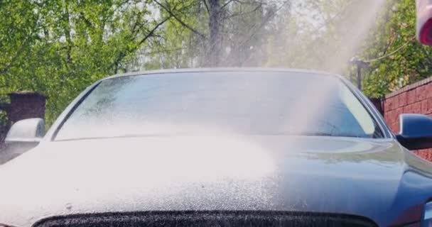 Coche de limpieza con lavadora a presión. Pulverización de espuma en el capó del coche. Servicio de lavado de coches y concepto de detalle — Vídeo de stock