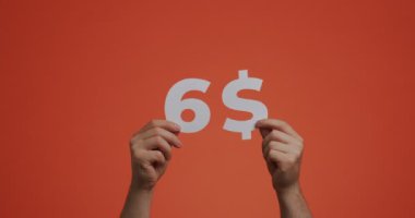 Six dollars, hands showing cost of purchase. Man show price. Sale, donating, charity, auction concept