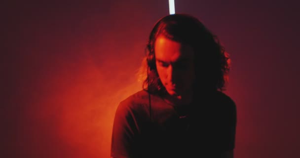 Tanec DJ mladý chlap nosí sluchátka světla na diskotéce během DJ vystoupení v nočním klubu — Stock video