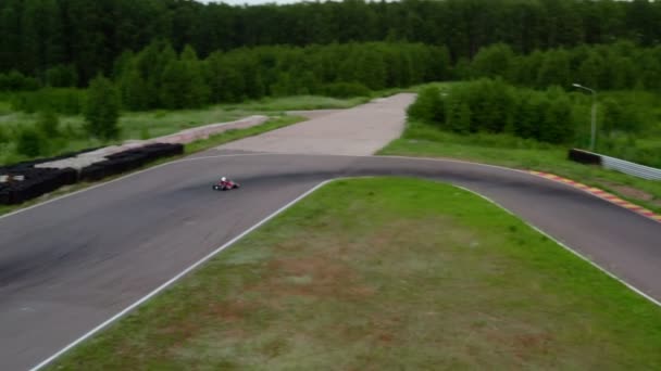 Kart racing on circuit, aerial view 4k video. Sports car for professional karting moving on racetrack. Race training — Stock Video