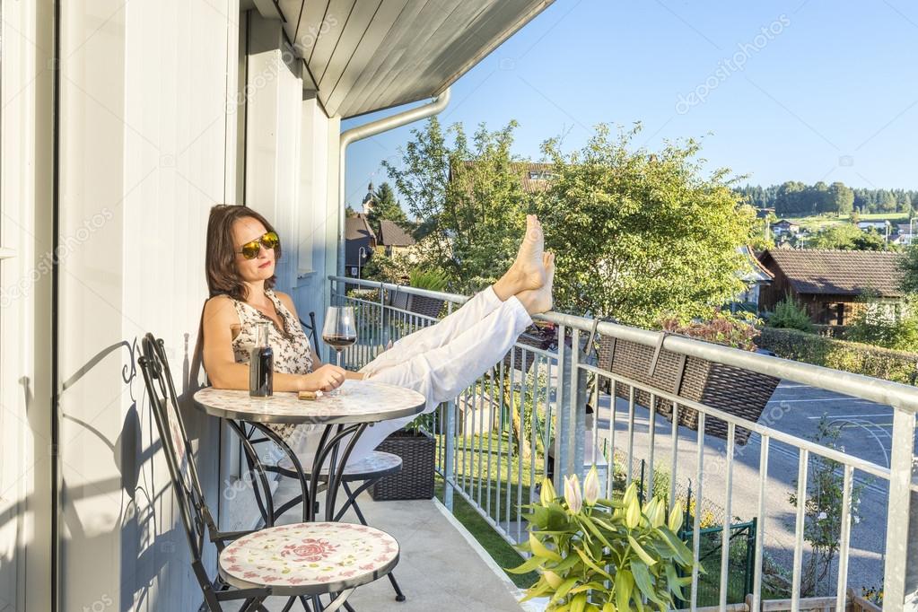 Cute woman drinking wine on a terrace