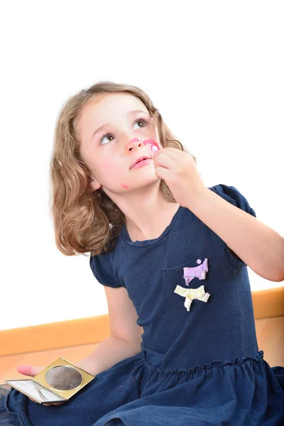 Little cute girl posing while panting her face — Stock Photo, Image