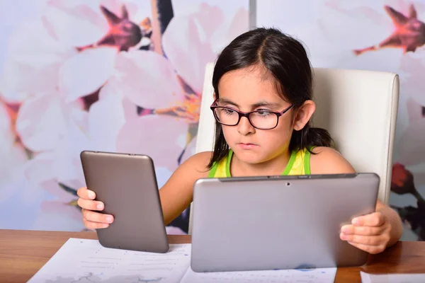 Meisje met behulp van een tablet-pc en een ebook voor huiswerk — Stockfoto