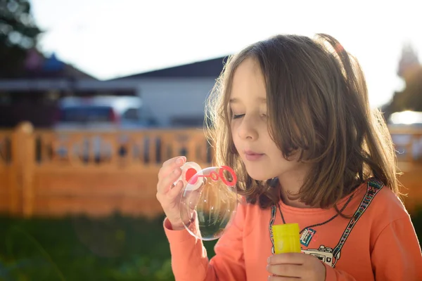 Little girl making soap bubbles — Stock Photo, Image