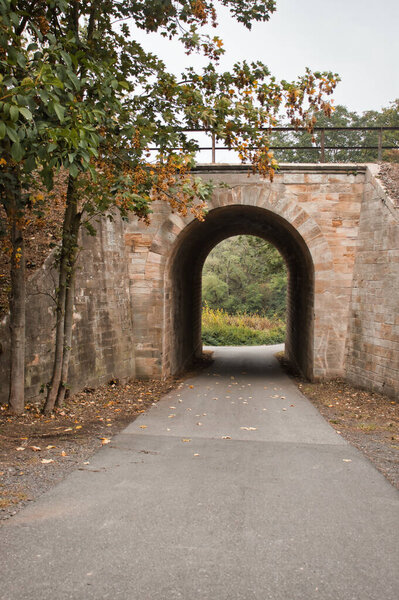 Arch leading into a small garden and walking path near Bockenheim, Germany on a fall day.