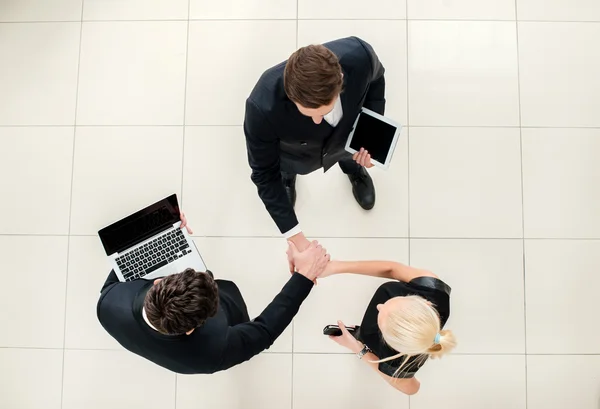 Business team. Top view of three business people in formal wear