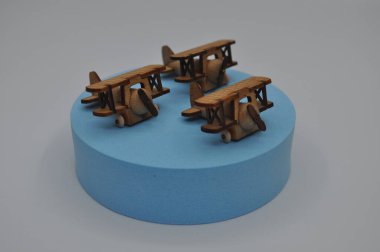 Tahtadan yapılmış küçük ahşap uçak modellerinin yaratıcı çekimlerini kapat. Boyutları yaklaşık 3 cm X 2 cm.