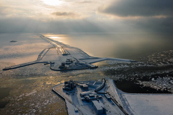 Panoramic aerial view of the complex of protective structures of St. Petersburg against floods. Navigable passage. Dam. Ring road. Winter.