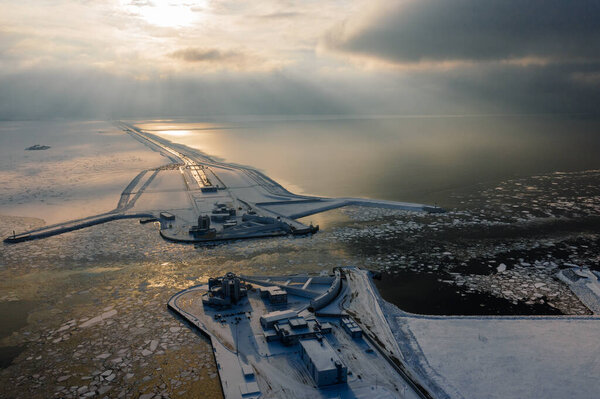 Panoramic aerial view of the complex of protective structures of St. Petersburg against floods. Navigable passage. Dam. Ring road. Winter.
