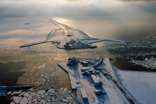 Panoramic aerial view of the complex of protective structures of St. Petersburg against floods. Navigable passage. Dam. Ring road. Winter.