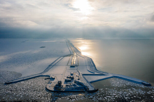 Panoramic aerial view of the complex of protective structures of St. Petersburg against floods. Navigable passage. Dam. Ring road. Winter.