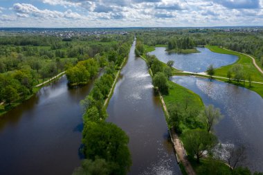 Göletlerin yüksekliğinden panoramik bir manzara Peterhof 'taki peyzaj parkı, çayır bahçesi, yürüyüş yolları, tahrip edilmiş pavyon.