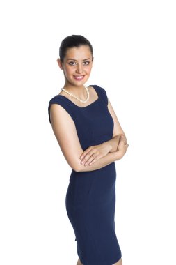 Young woman in strict blue dress with a pearl necklace, in a clo