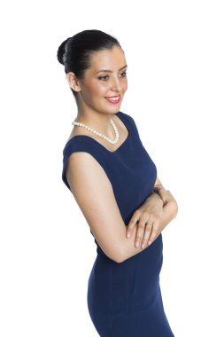 Young woman in strict blue dress with a pearl necklace, in a clo