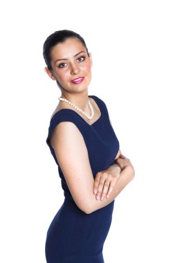Young woman in strict blue dress with a pearl necklace, in a clo