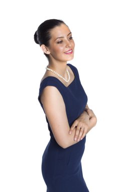 Young woman in strict blue dress with a pearl necklace, in a clo