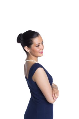 Young woman in strict blue dress with a pearl necklace, in a clo