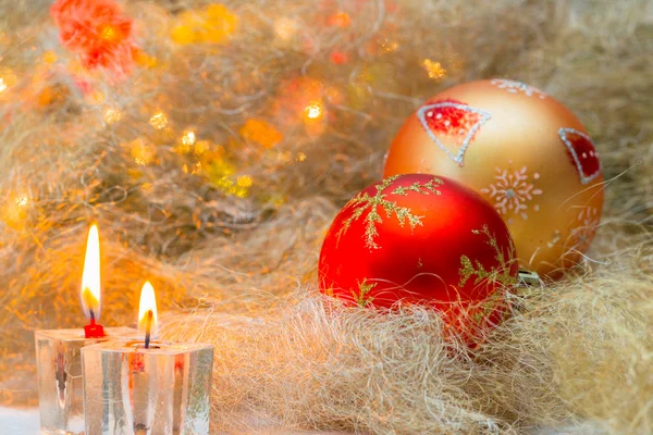 Christmas balls with candles on the background lights — Stock Photo, Image